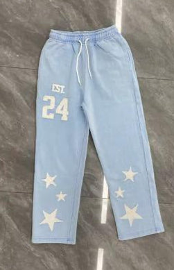 Light blue pants with star patterns and number '24' on a gray floor.